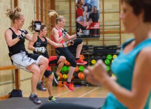 3 people doing a kick boxing class