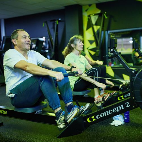 Man and woman using a rowing machine at Bluecoat Sports