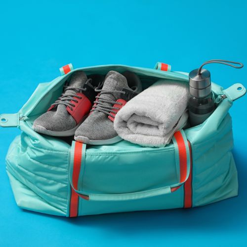 Gym towel and shoes in gym bag