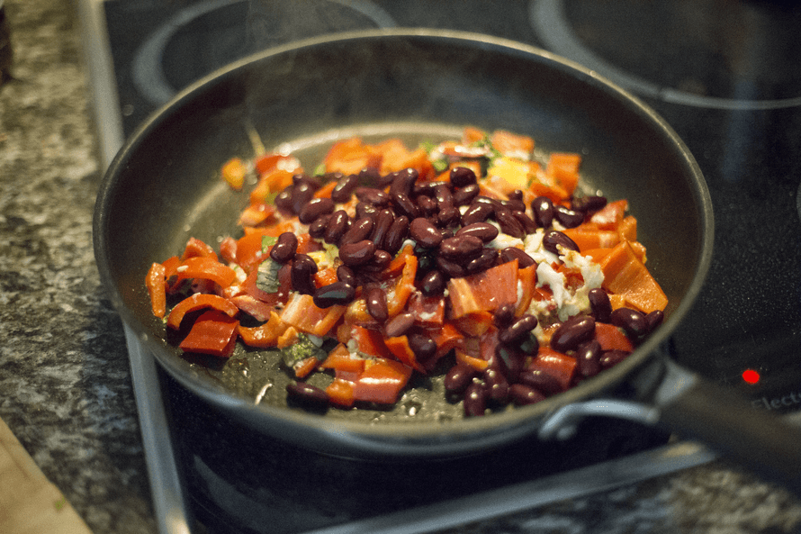 Frying pan with beans and vegetables