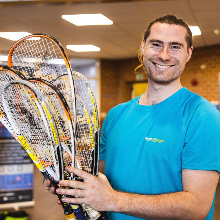 Kit Pearman holding squash rackets