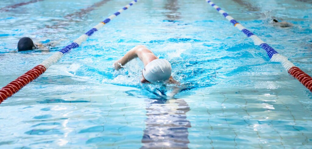 Man swimming in Bluecoats swimming pool