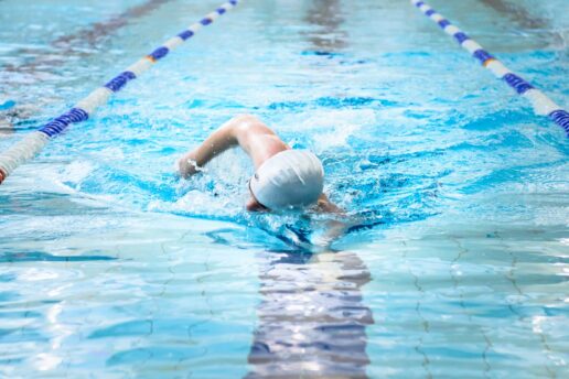 Man swimming in Bluecoats swimming pool