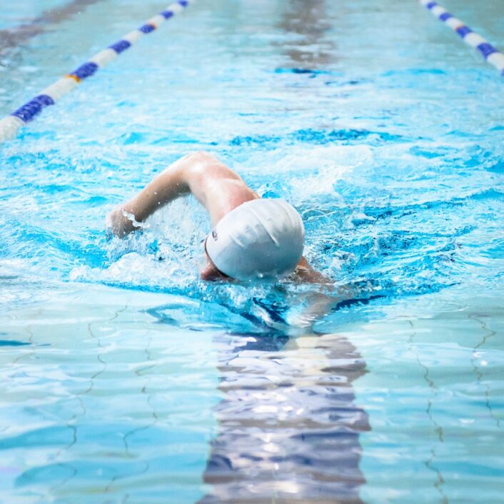 Man swimming in Bluecoats swimming pool