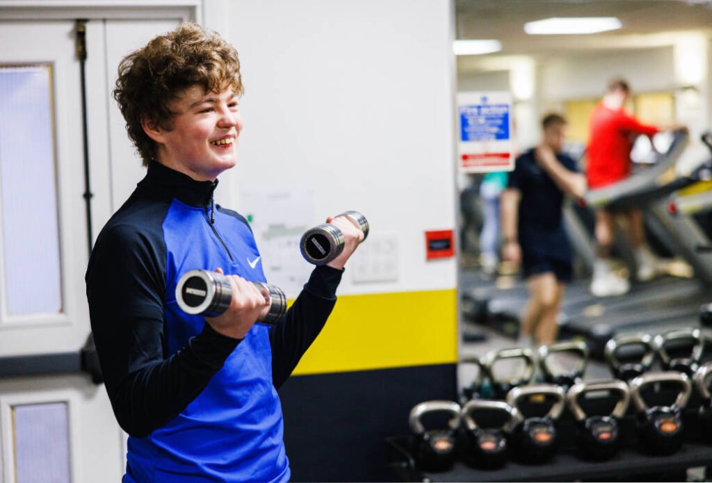 A teenage member using the gym
