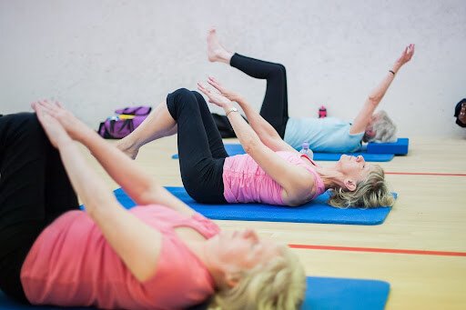 3 ladies in a yoga class