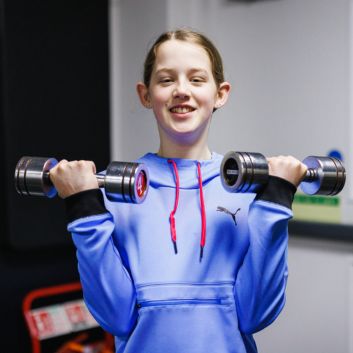 young girl lifting weights