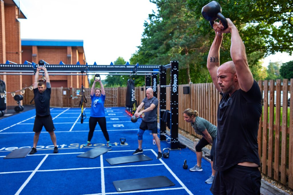 people lifting kettlebells on a workout