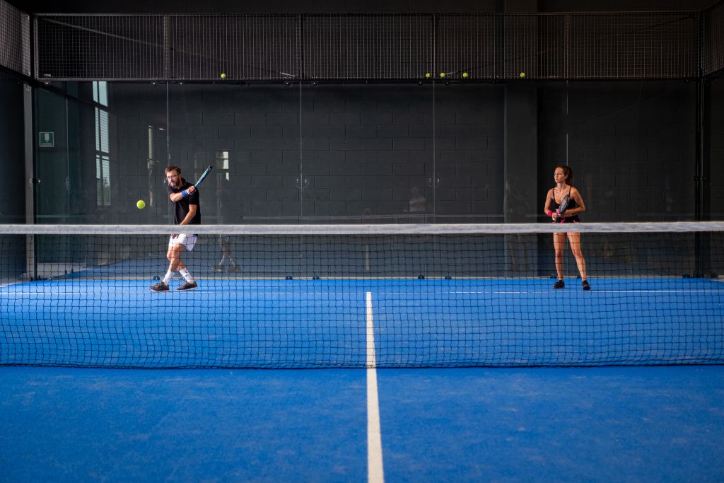 Two people playing padel