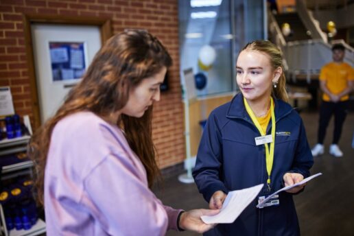 Two people at Bluecoat Sports looking at paperwork