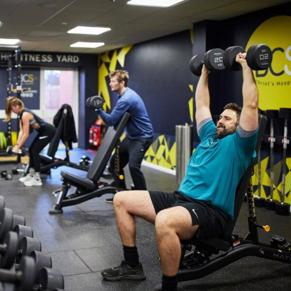 2 men and 1 woman lifting weights