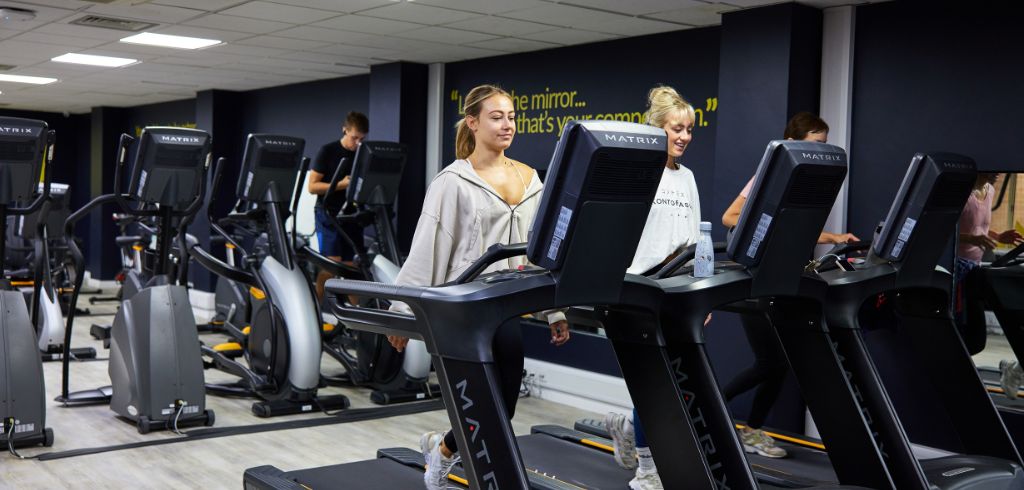 people working out on matrix running machines