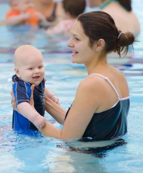 mother and baby in a pool