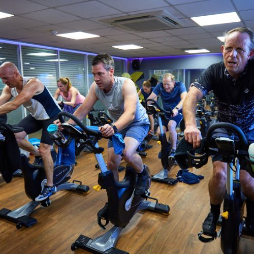 An indoor cycling class at Bluecoat Sports
