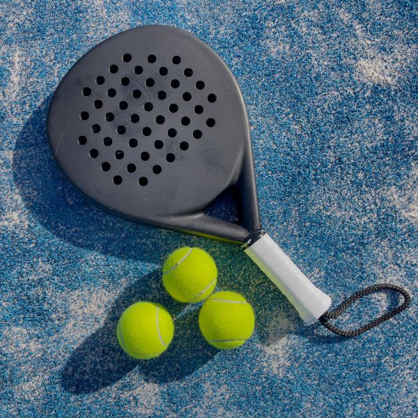 Padel racket and three padel balls
