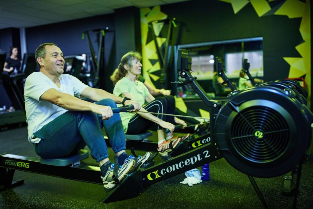 A man and a woman using a rowing machine in Bluecoat Sports