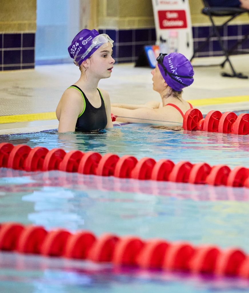 two children swimming