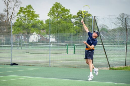 Man playing tennis outdoors at Bluecoat Sports