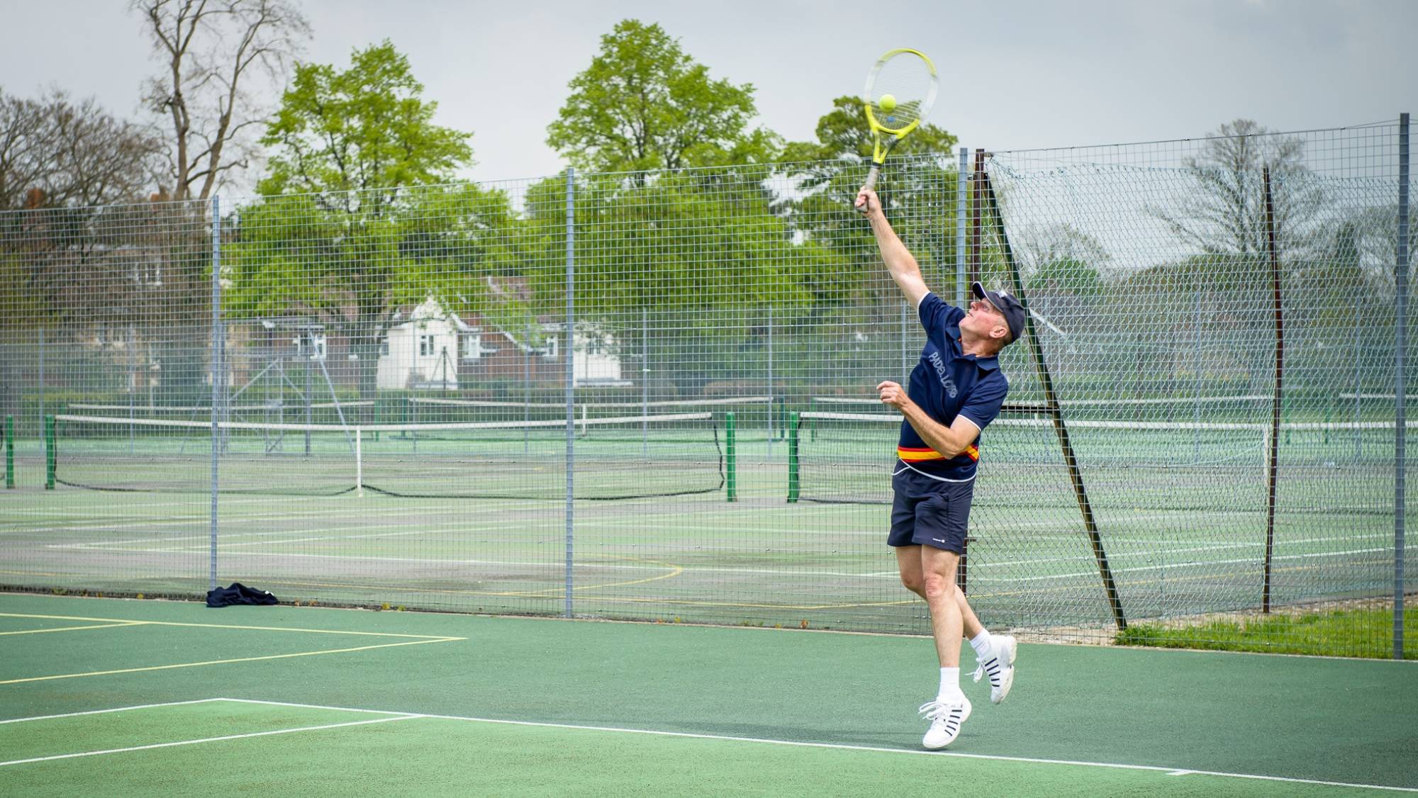 Man playing tennis outdoors at Bluecoat Sports