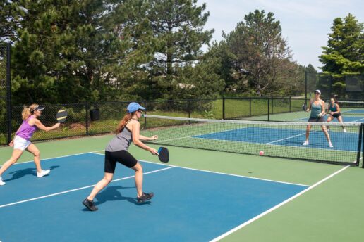 women playing pickleball