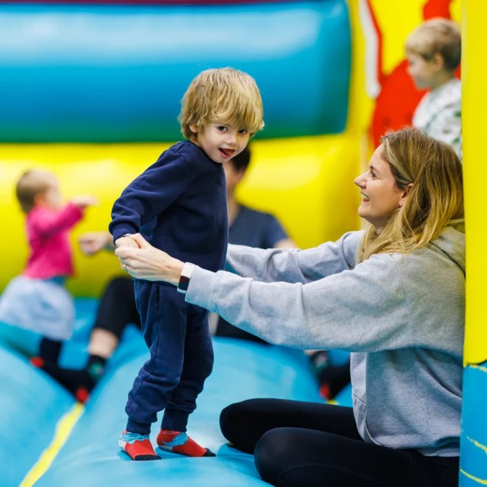 parent with child on a bouncy castle