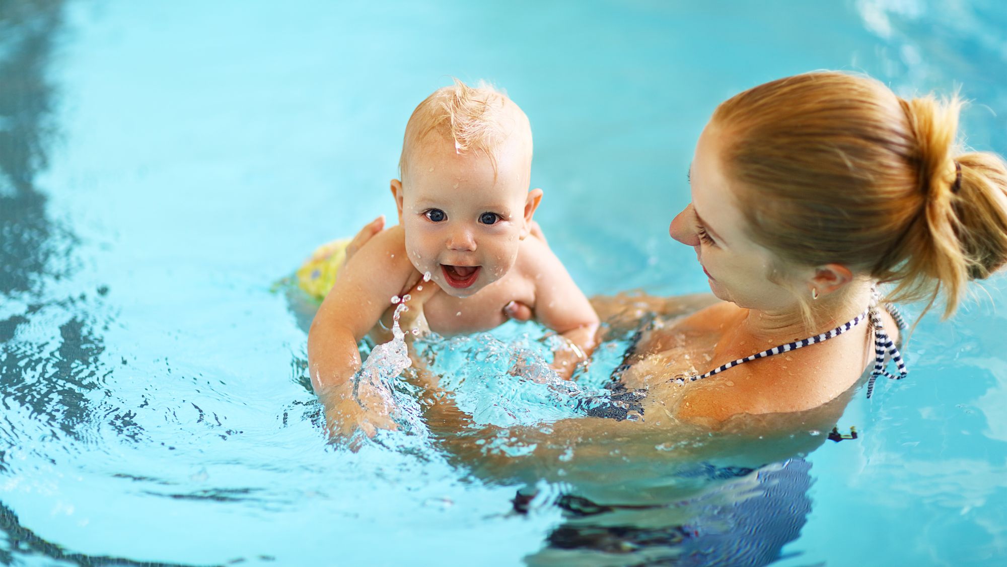 mum and baby in swimming pool
