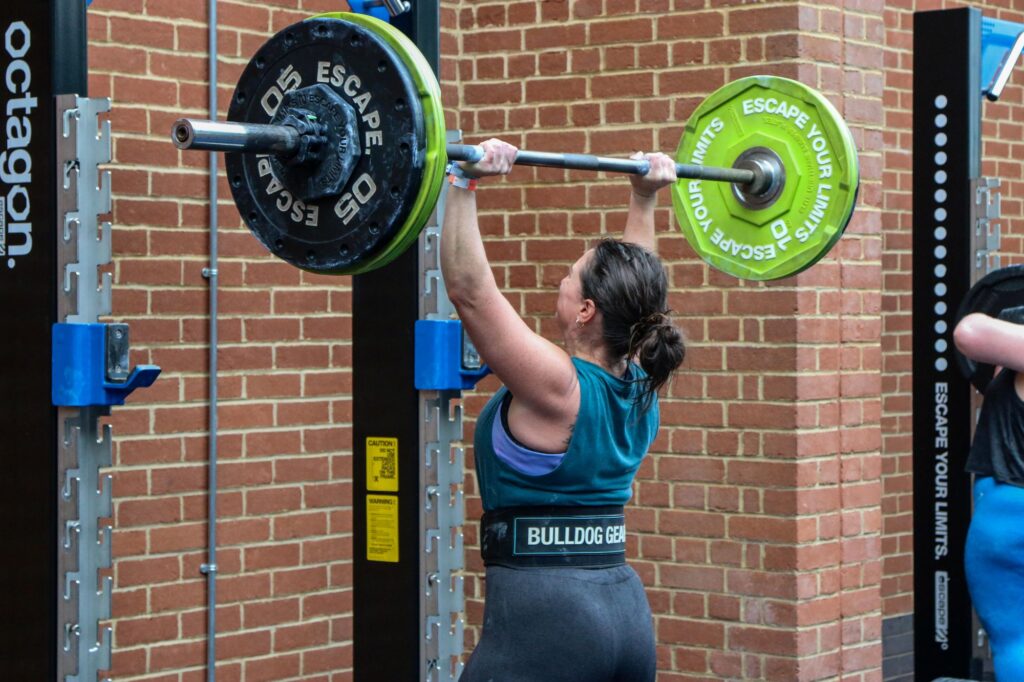 woman performing barbell lift