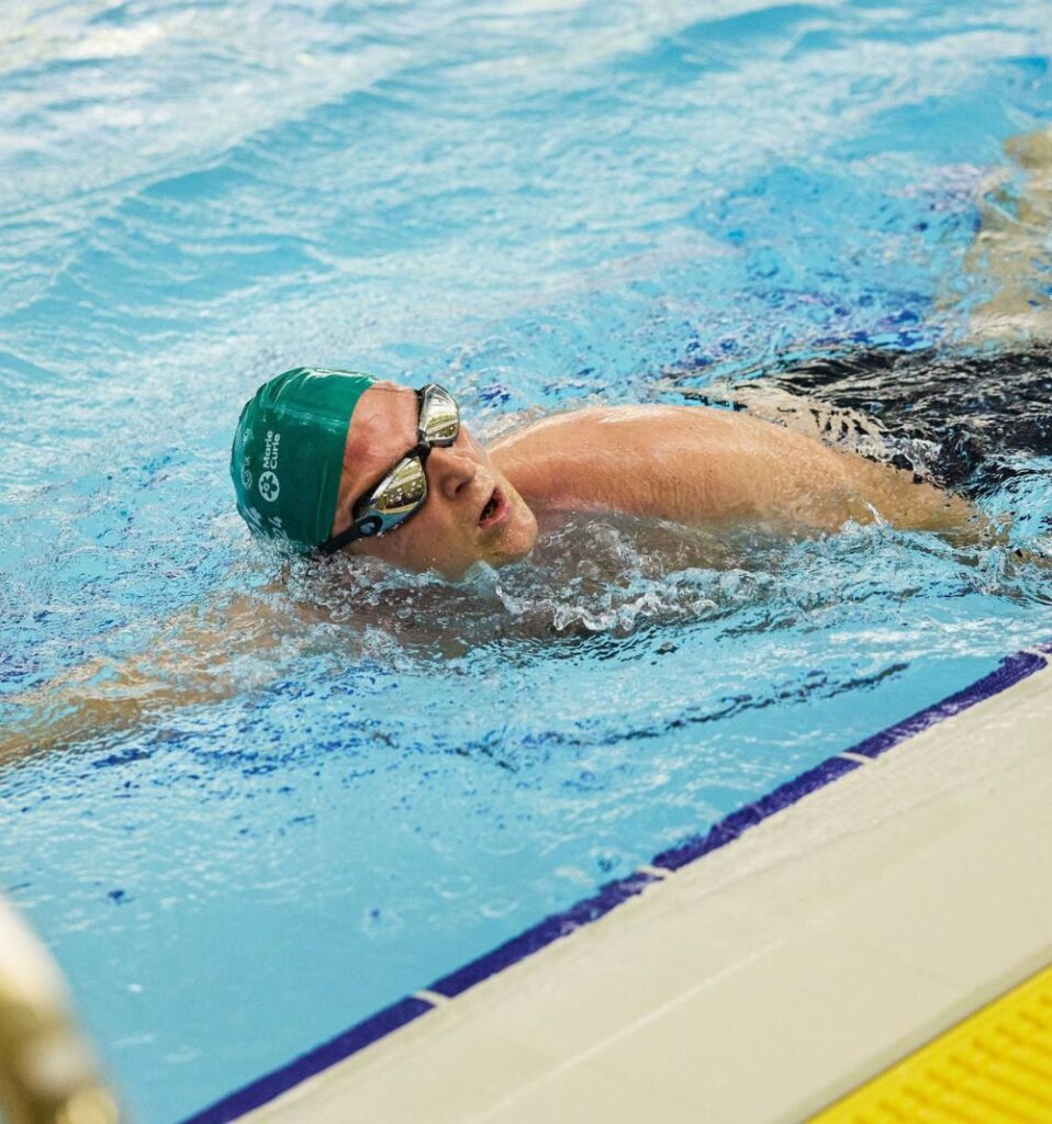 man swimming in pool