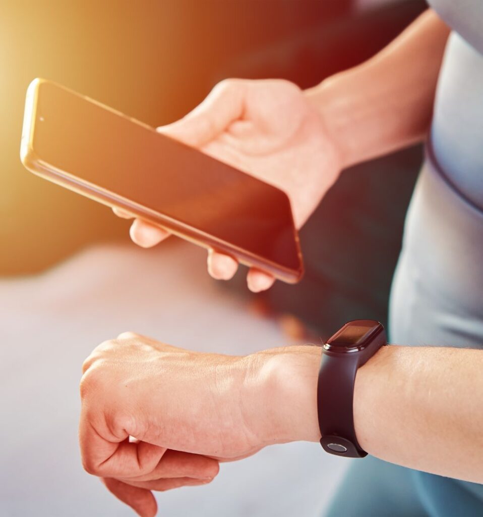 person tracking their workout on watch and phone