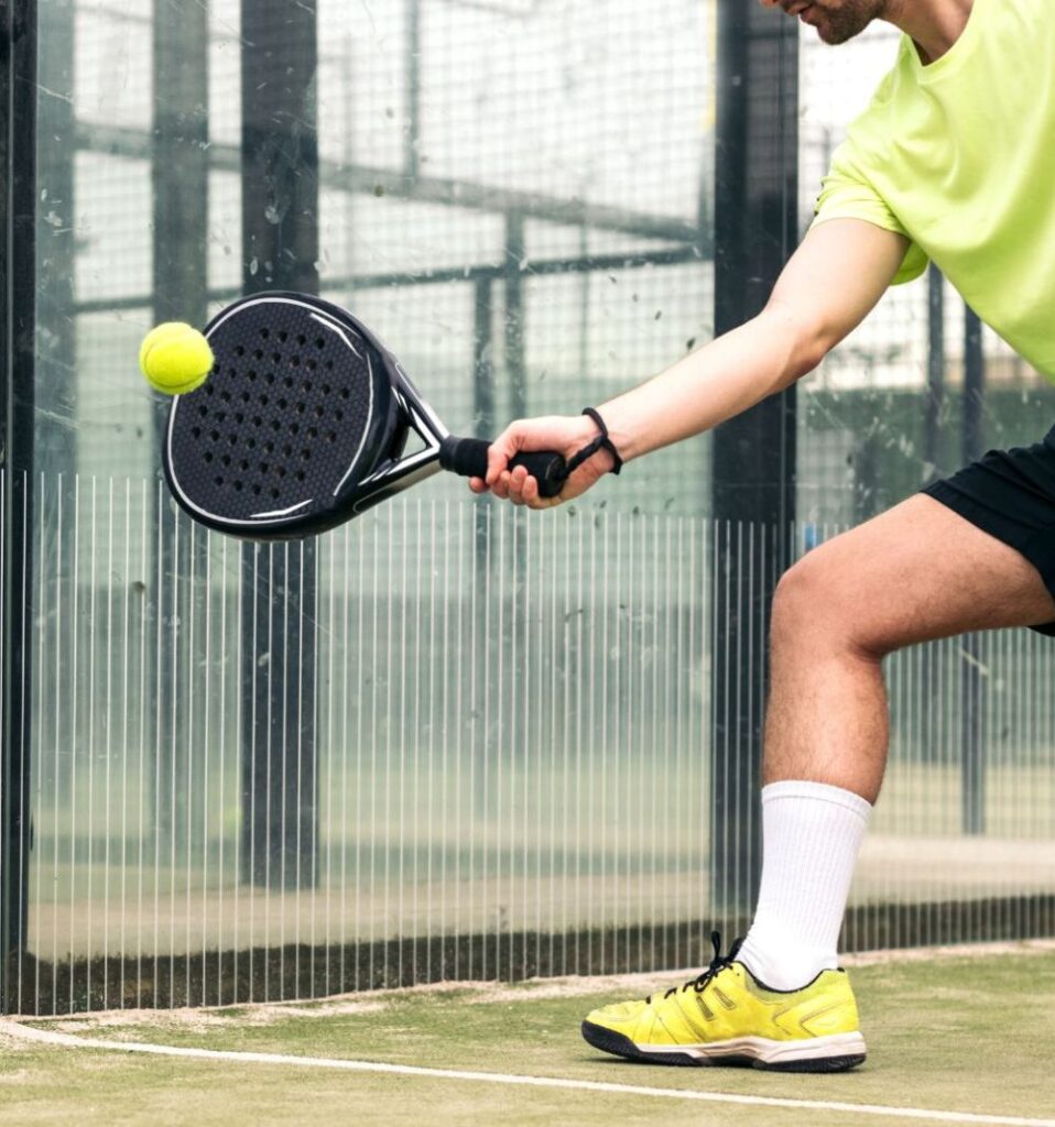 man hitting a padel ball with padel racket