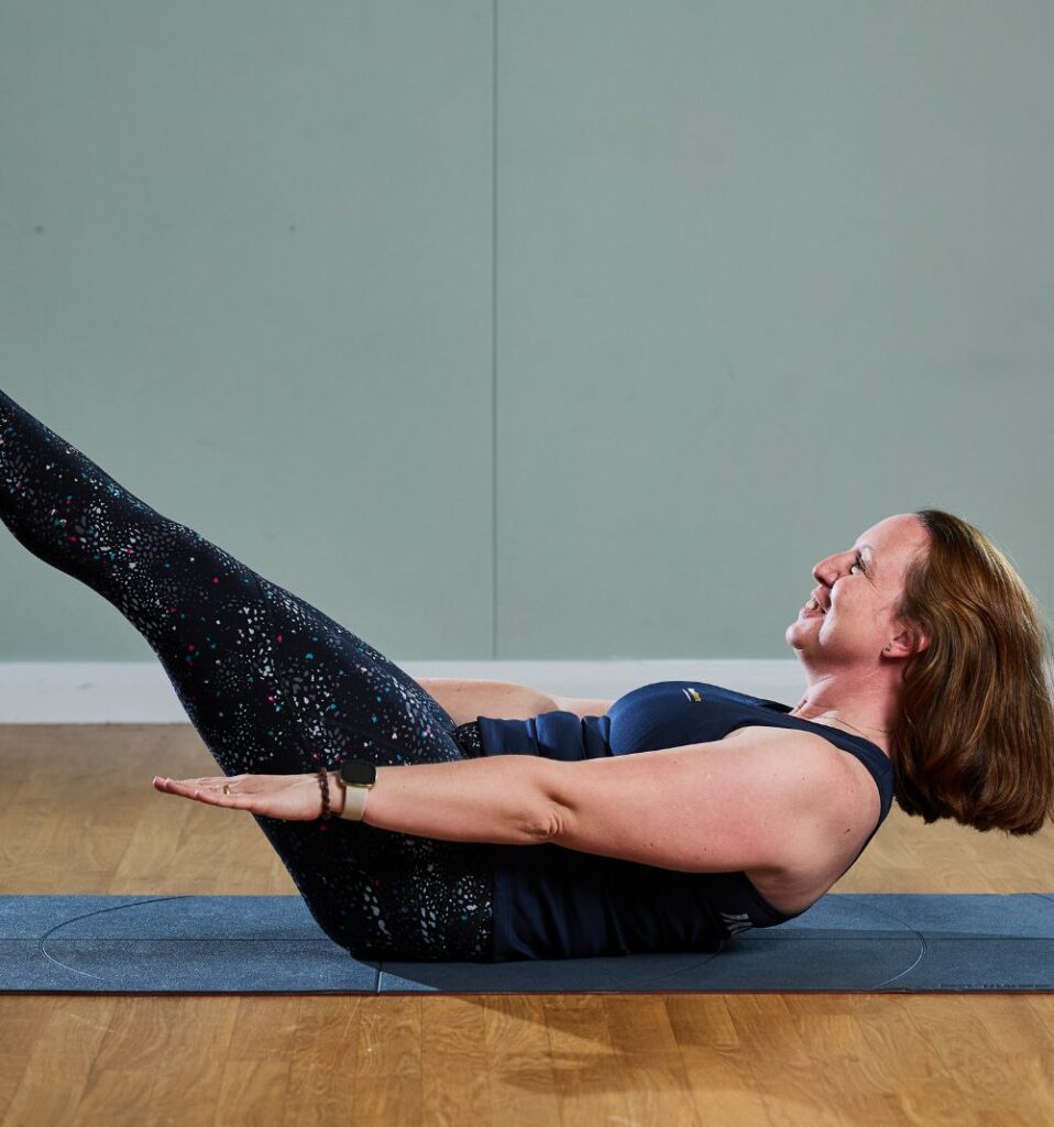 pilates instructor holding a core pose