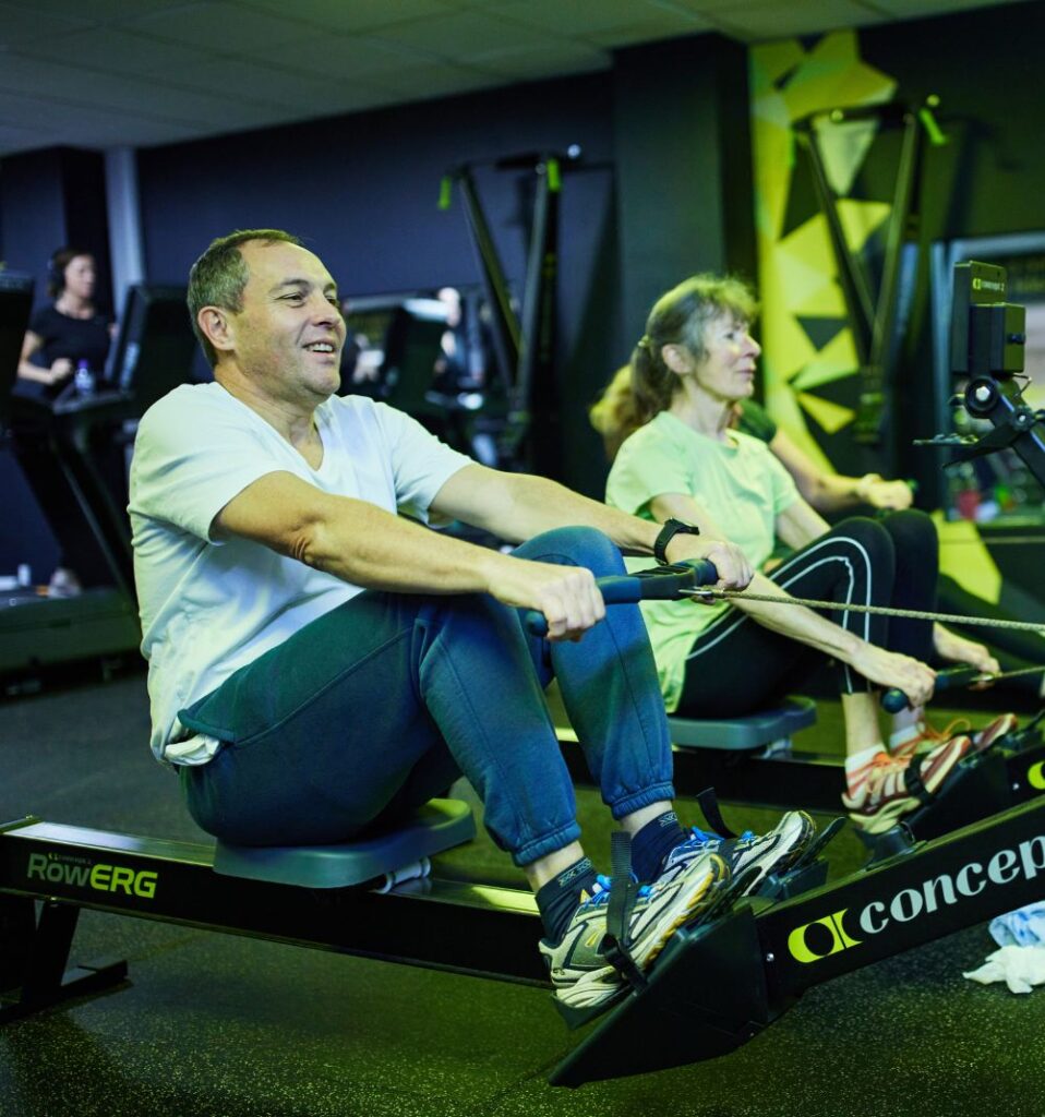 man and woman on rowing machines in bluecoat sports fitness suite