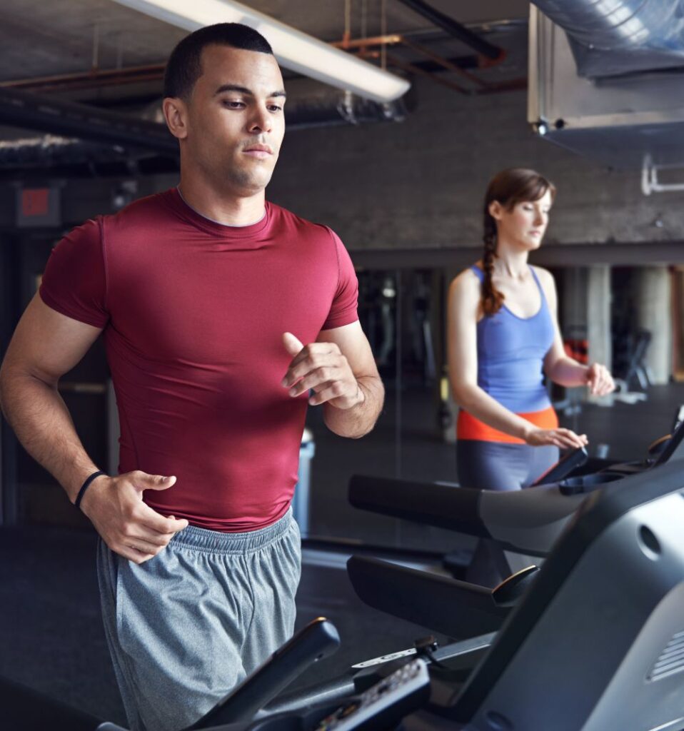 man and woman on treadmills