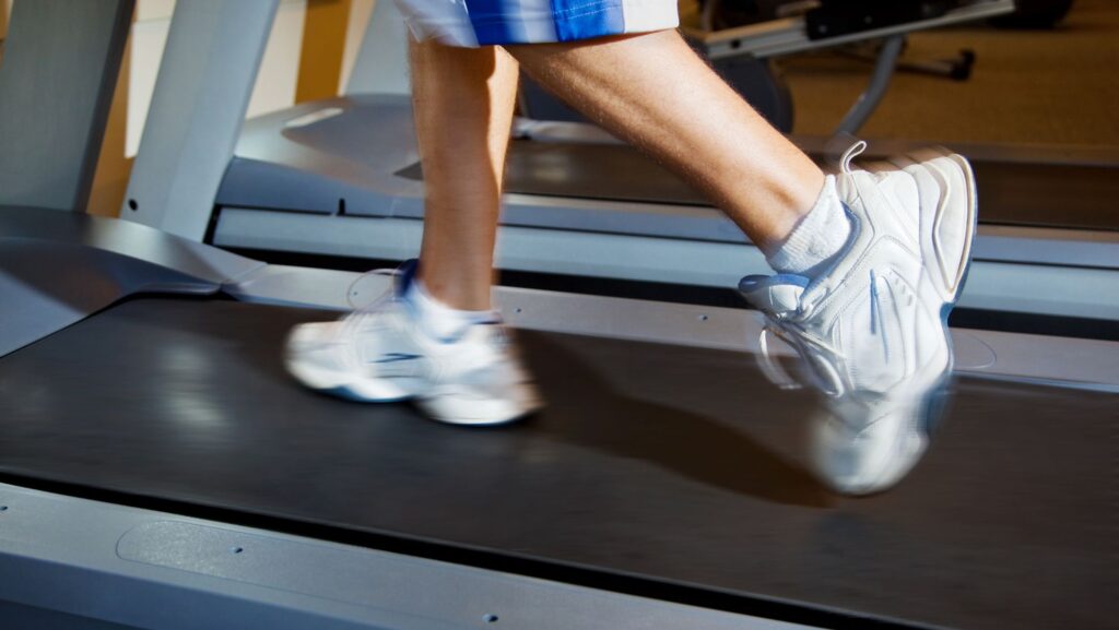 close up of persons shoes running on treadmill