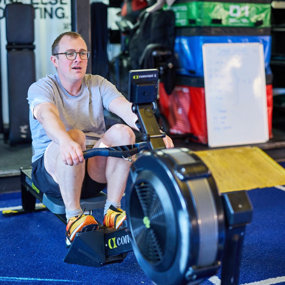 man on rowing machine in outdoor fitness yard