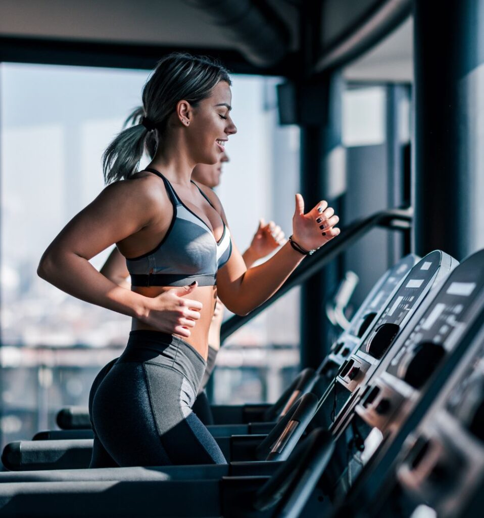 women running on treadmill in the morning