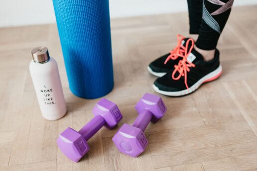 person standing by workout equipment on wood floor