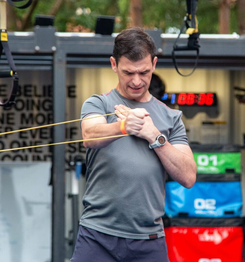 man warming up with resistance band chest exercise