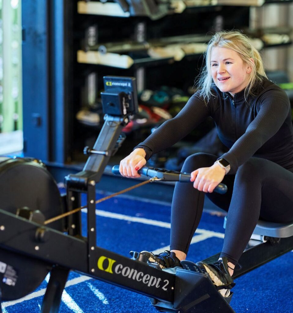 woman on rowing machine in outdoor fitness yard
