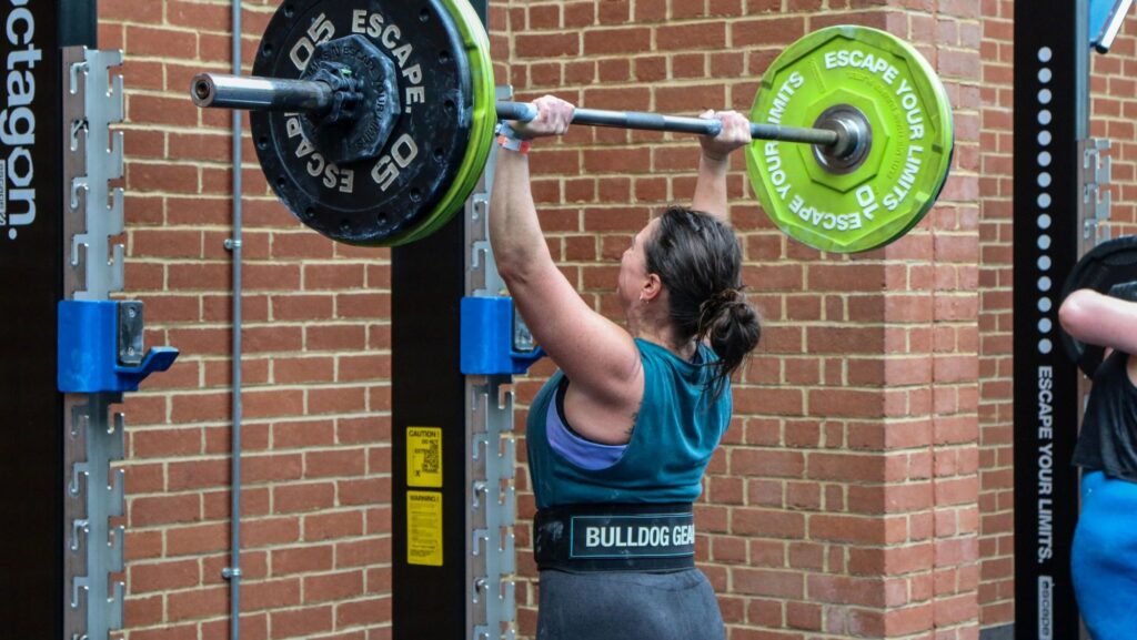 woman lifting barbell in outdoor fitness yard at bluecoat sports