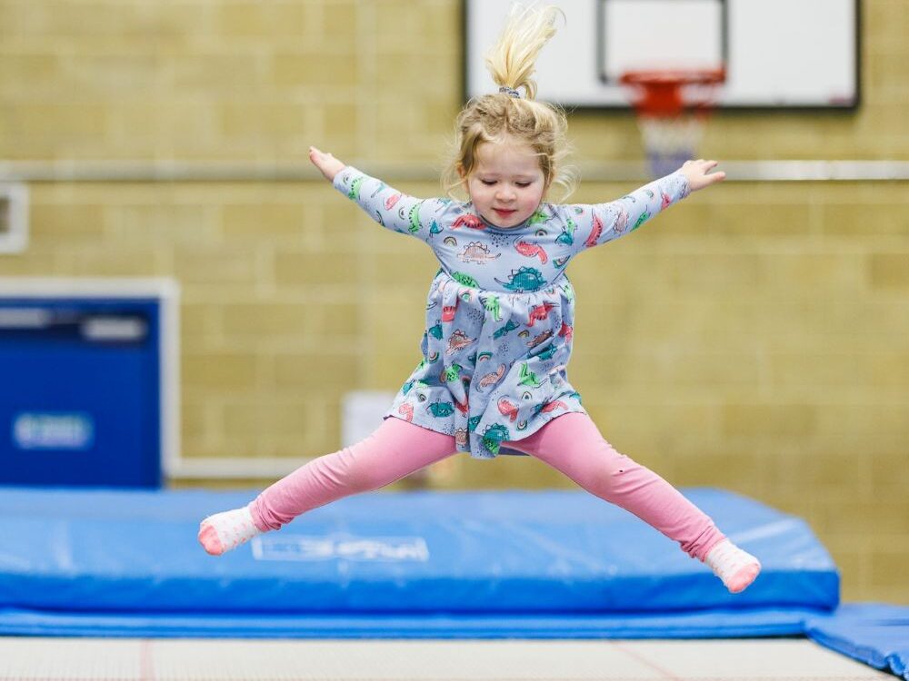 child jumping on a trampoline