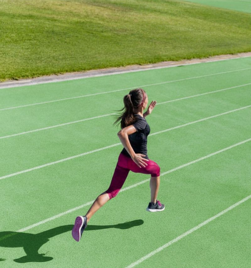 woman running on athletics track