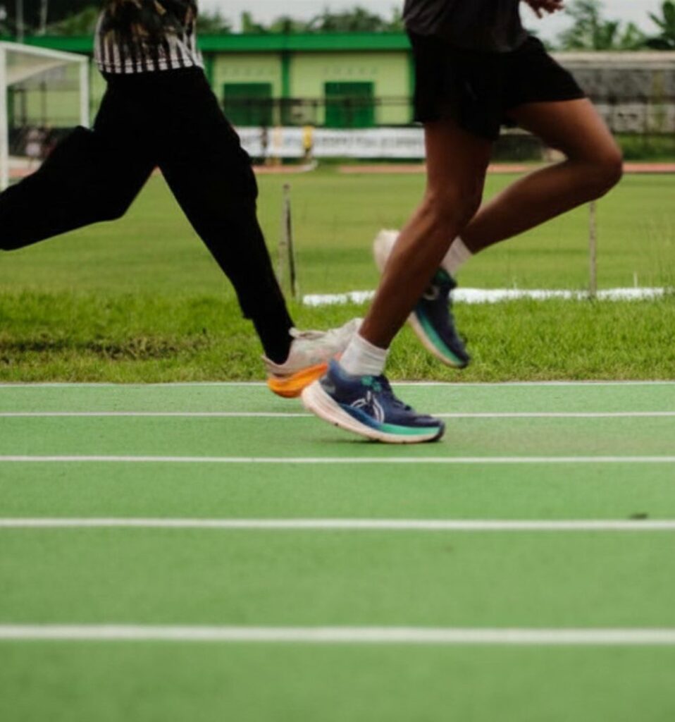 two people running on a running track