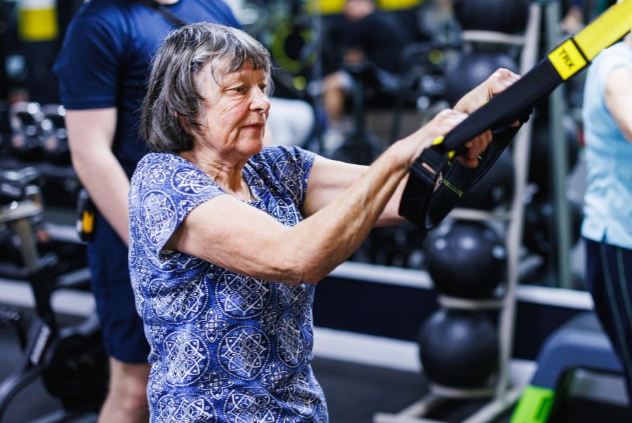 senior women exercising with the trx in the gym at Bluecoat Sports