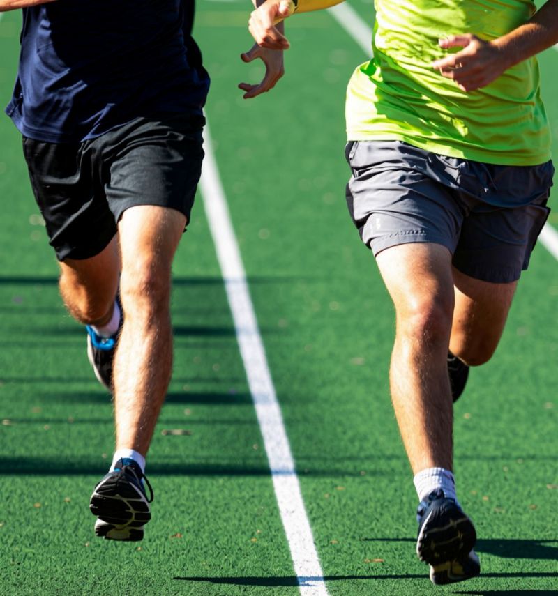two people running on an athletics track together