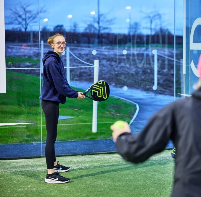 woman learning padel