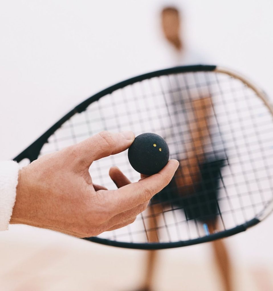 close up of squash ball and racket before serve